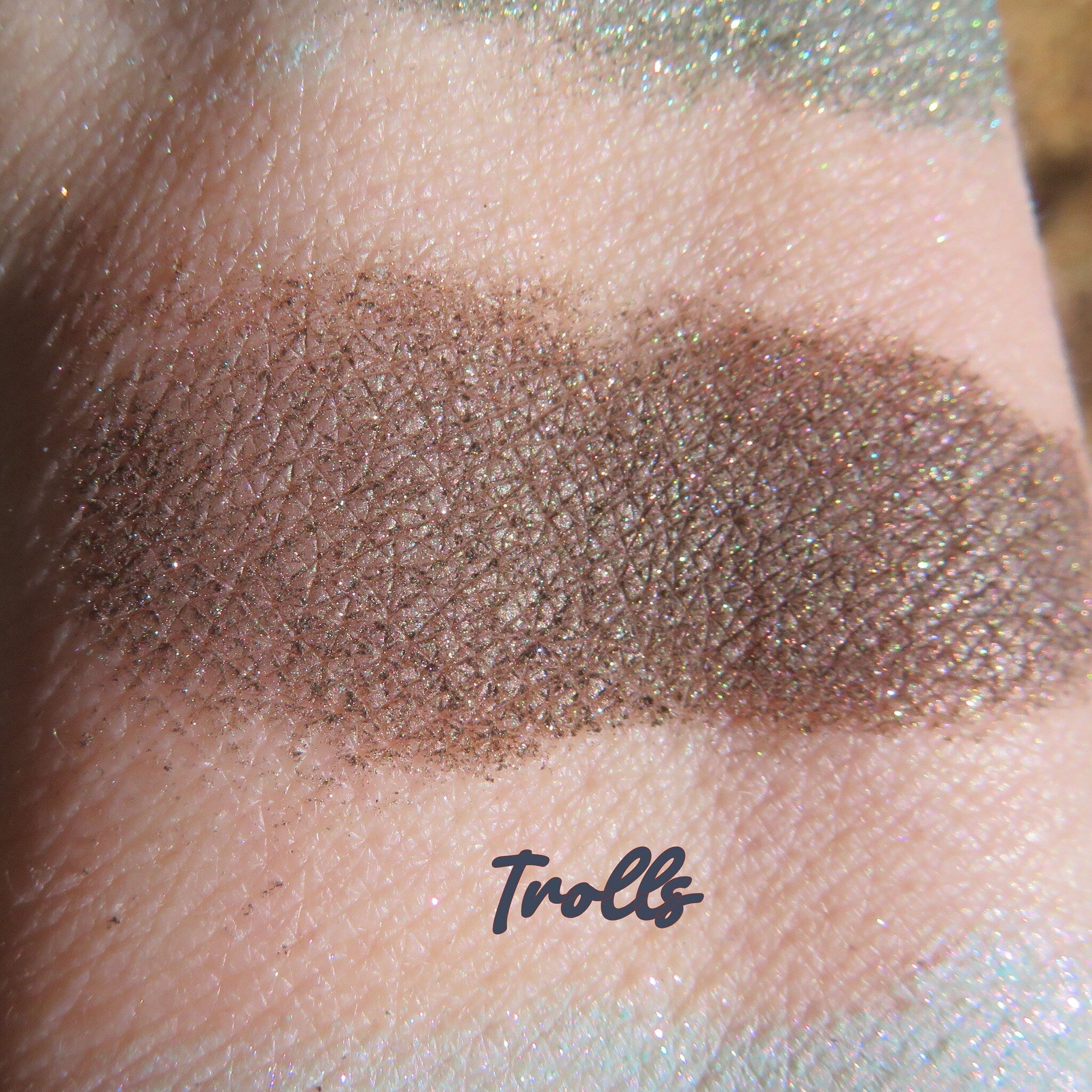 Side view of rich dark brown vegan loose mineral eyeshadow with shimmer pigment in a small open jar
