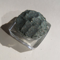 Glitter eyeshadow in dark green with sparkly finish, in clear square container