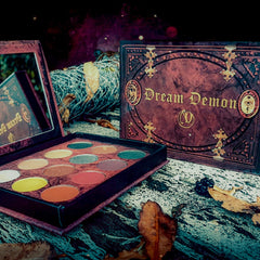 Side view of Dream Demon Eyeshadow Palette showcasing 12 vibrant matte and shimmer shades in sleek black compact