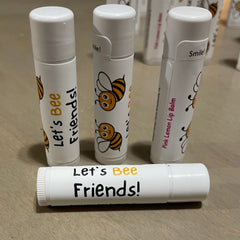 Lip balm tubes with white and bee design, "Let's Bee Friends!" text, Sweet Honey Farm brand