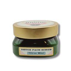 Detox face scrub jar with gold lid and green glass, labeled Citrus Mint, Atomic Age brand