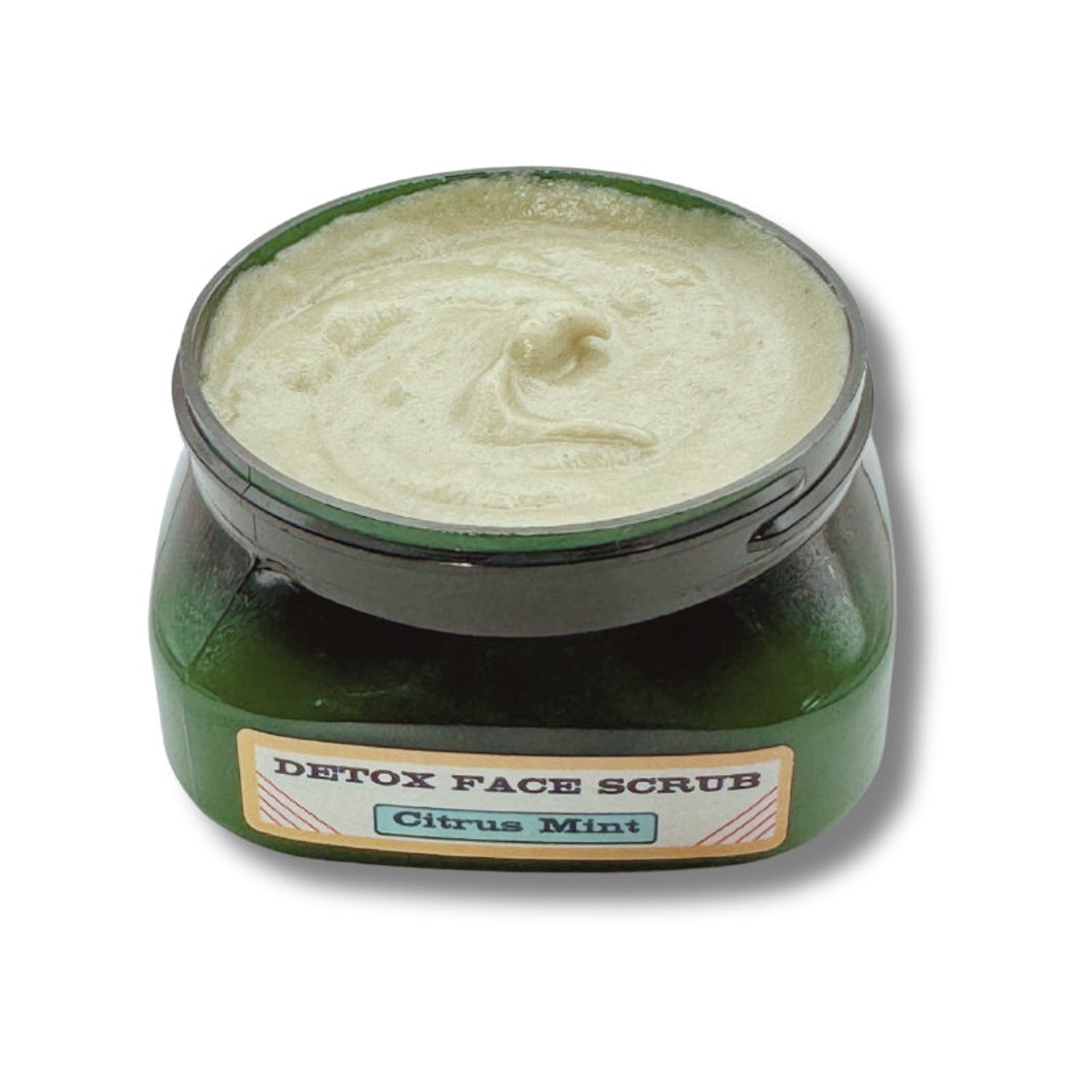 Face scrub jar, green glass container, light cream-colored scrub, "Detox Face Scrub" label, "Citrus Mint" text