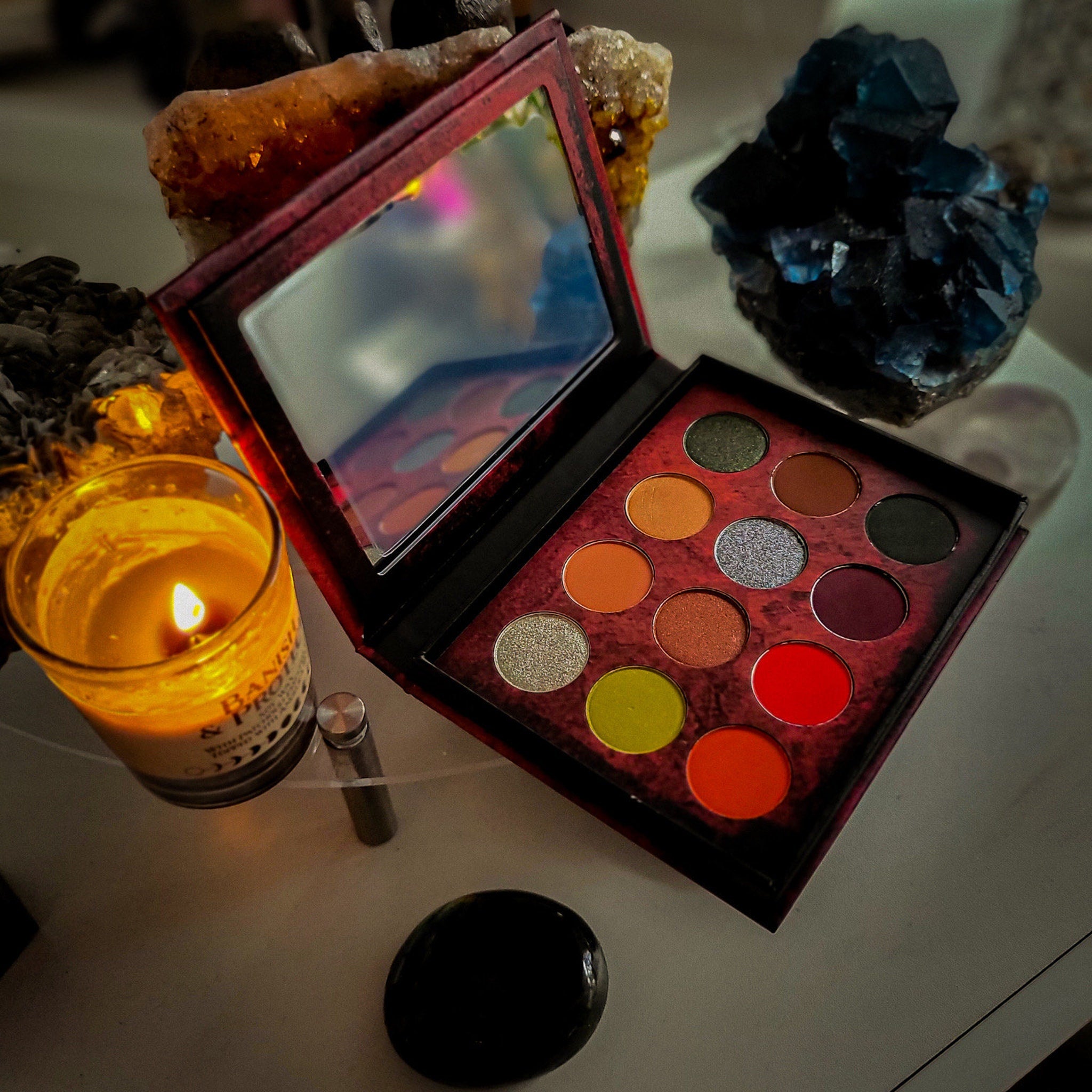 Side view of Dream Demon Eyeshadow Palette showing sleek black case with rainbow shimmer shades