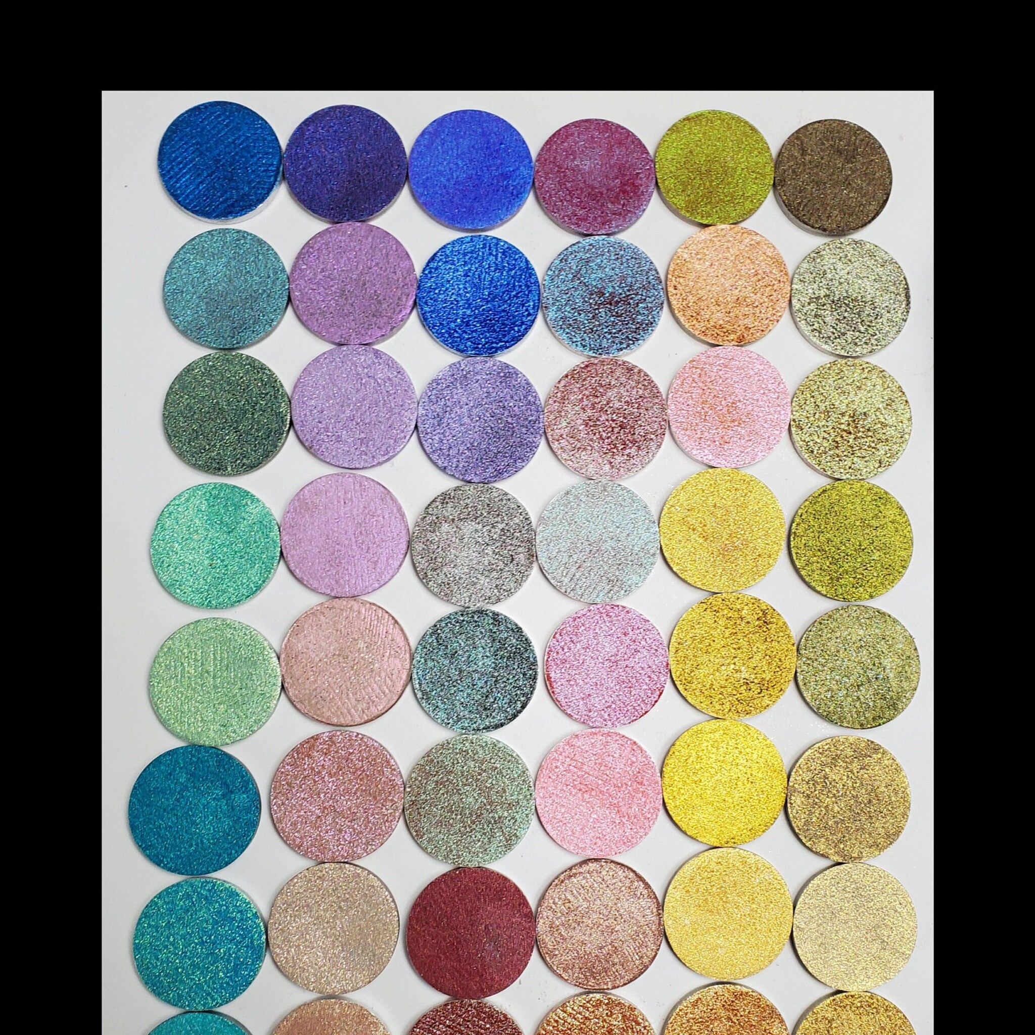 Five square eyeshadow pans in a sleek black palette with customizable color selection