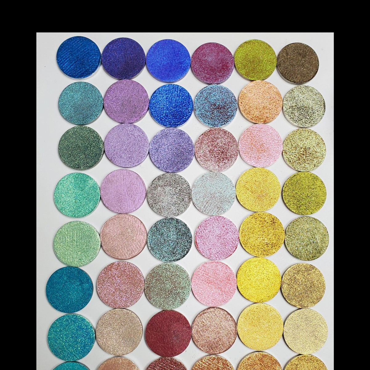 Five square eyeshadow pans in a sleek black palette with customizable color selection