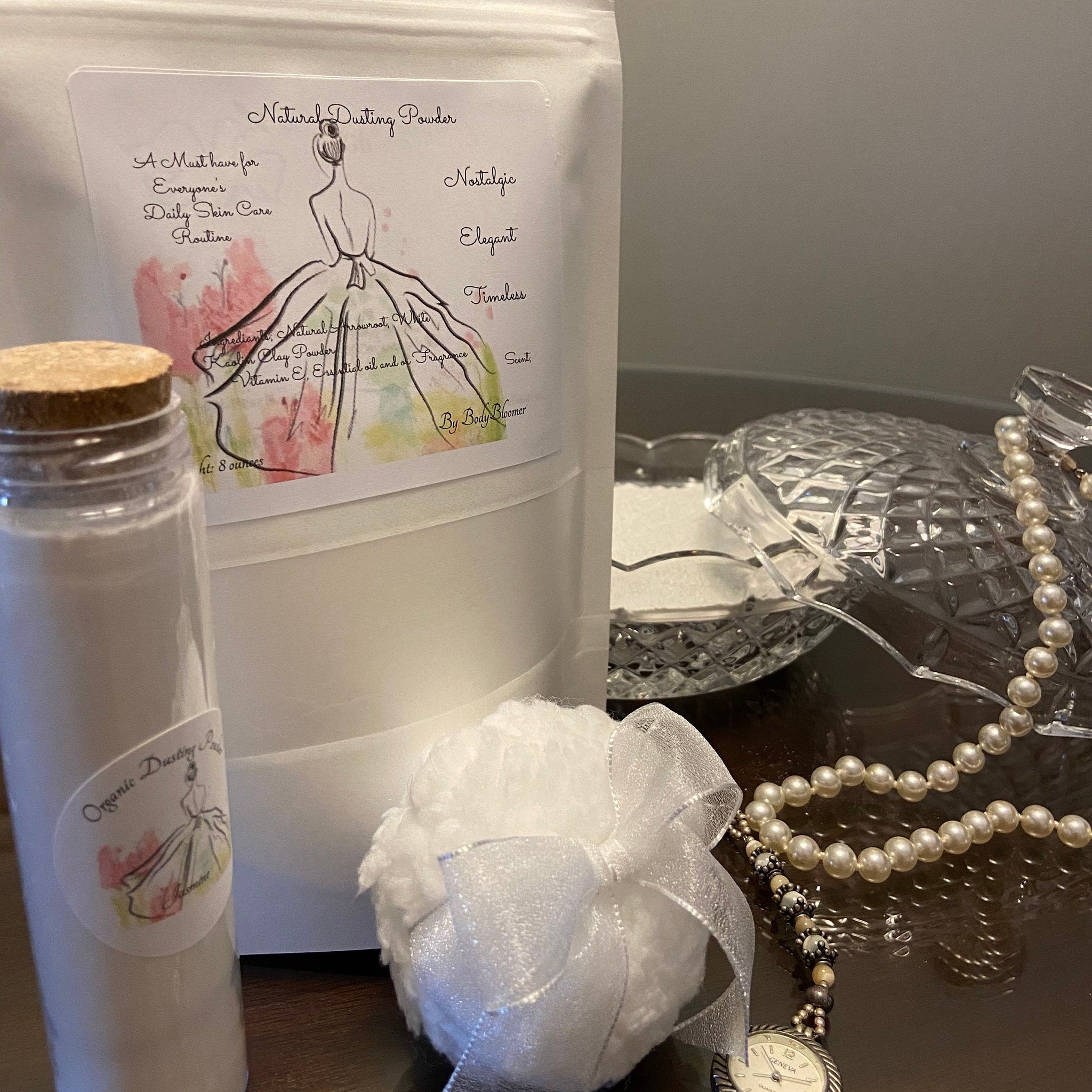 Dusting powder in white bag and jar, with white puff and pearl necklace, By Body Bloomer label