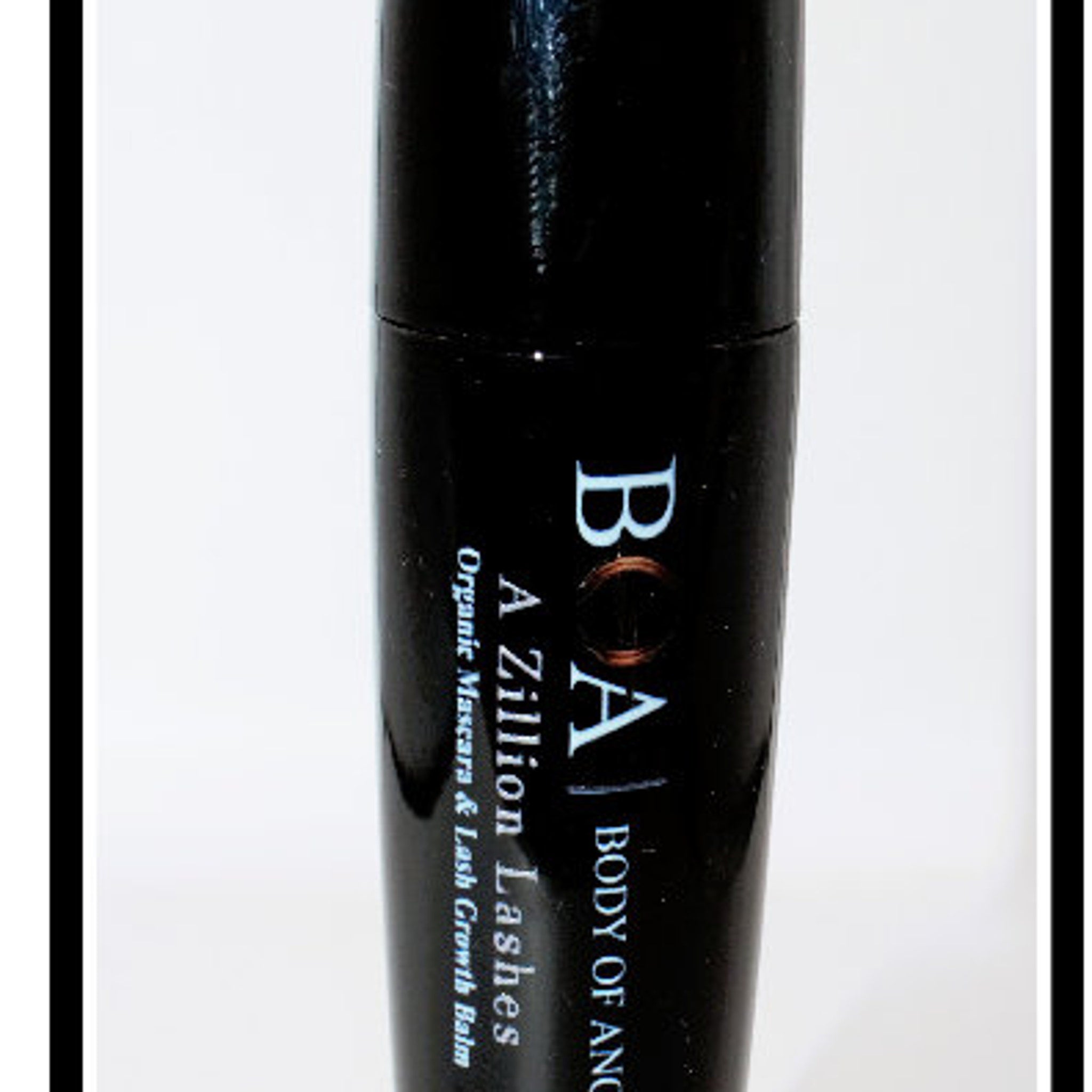 Mascara tube, black with white text, "BOA A Zillion Lashes" visible on the bottle.