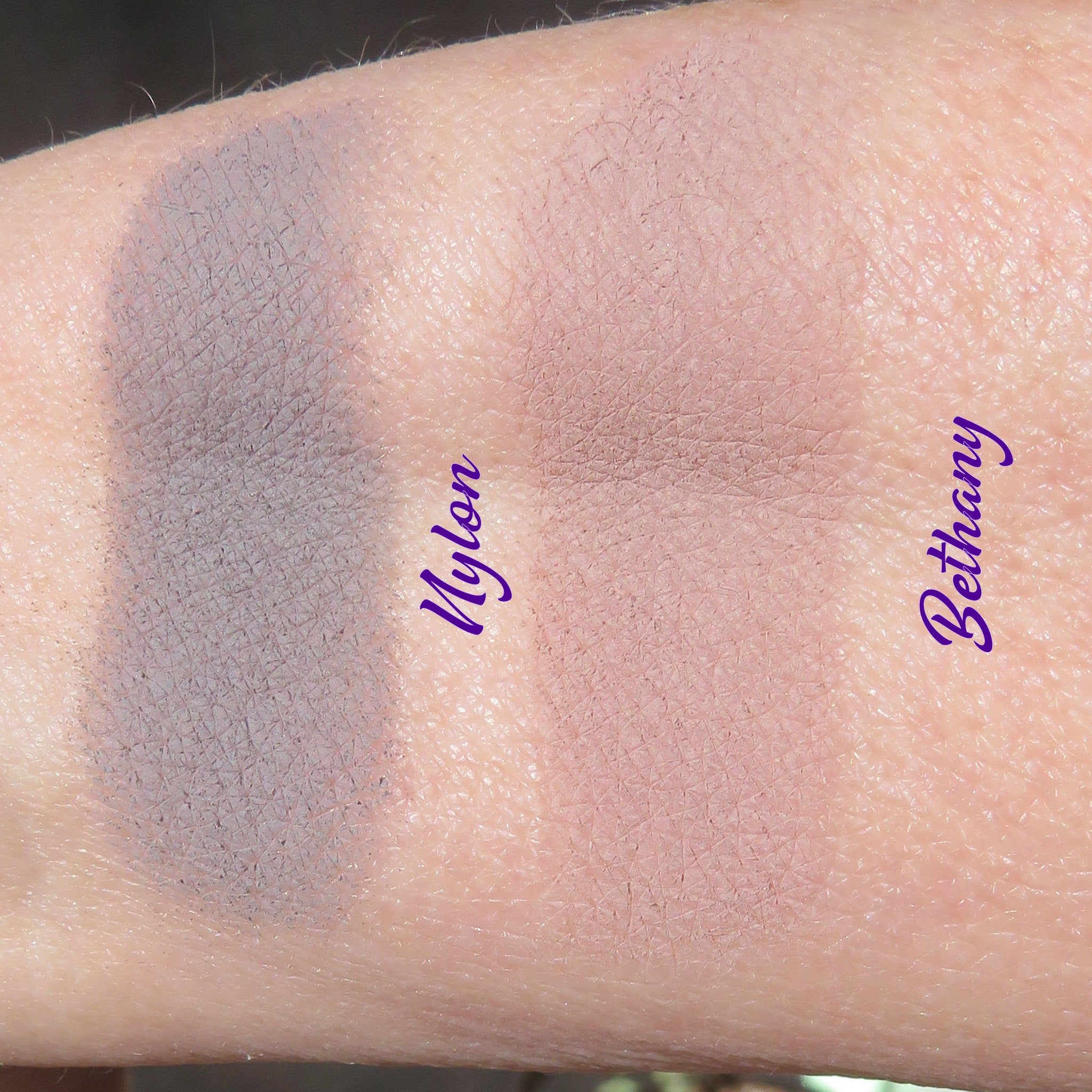 Eyeshadow swatches, gray and pink powder, skin texture, "Nylon" and "Bethany" text
