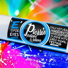 Eye cream tube with white, black, and blue label, "Pickles" brand, and colorful background