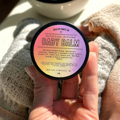 Premium glass jar of whipped tallow baby balm with gold lid and creamy white texture
