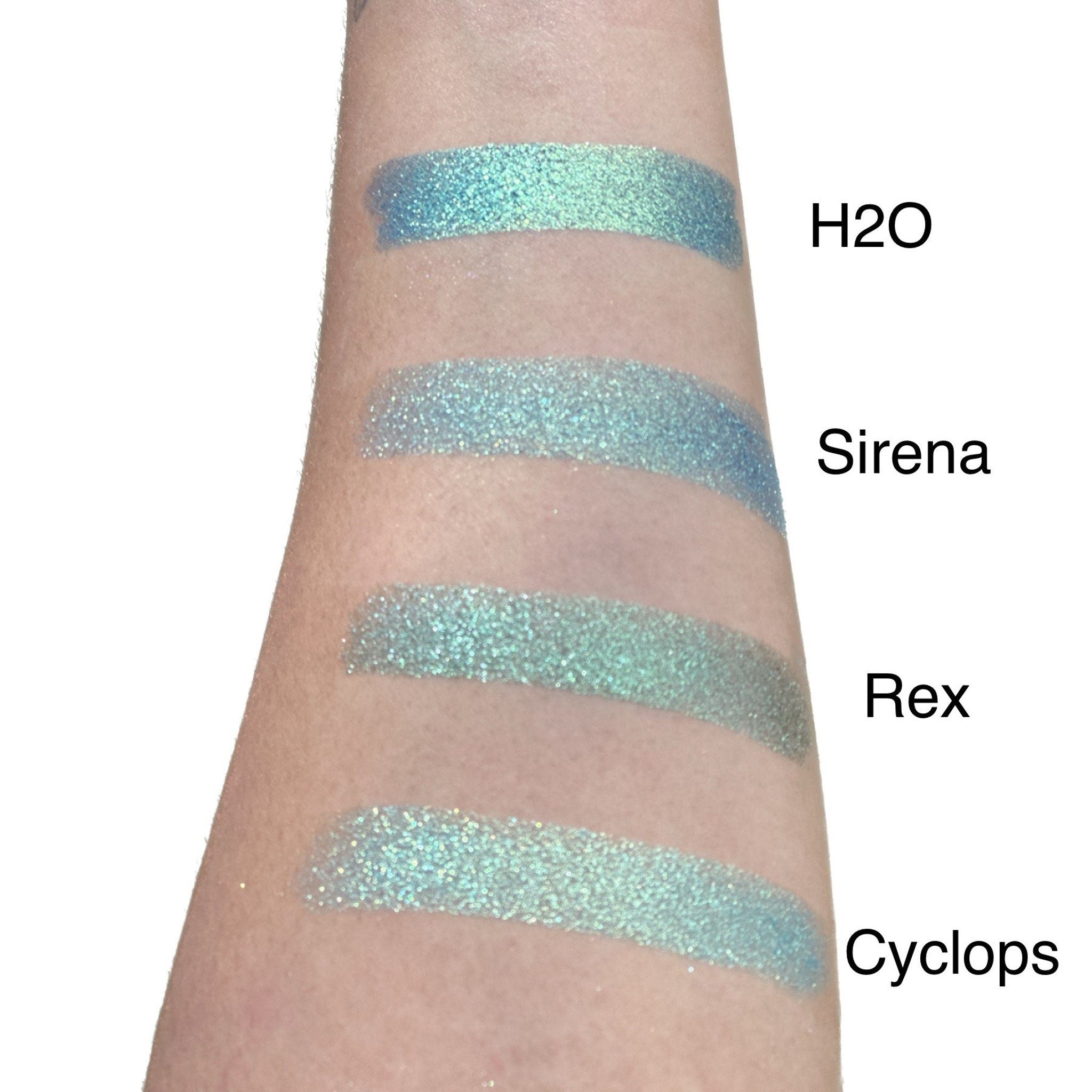 Top-down view of duo chrome eyeshadow single pan in sleek black compact with open lid showing iridescent pigment