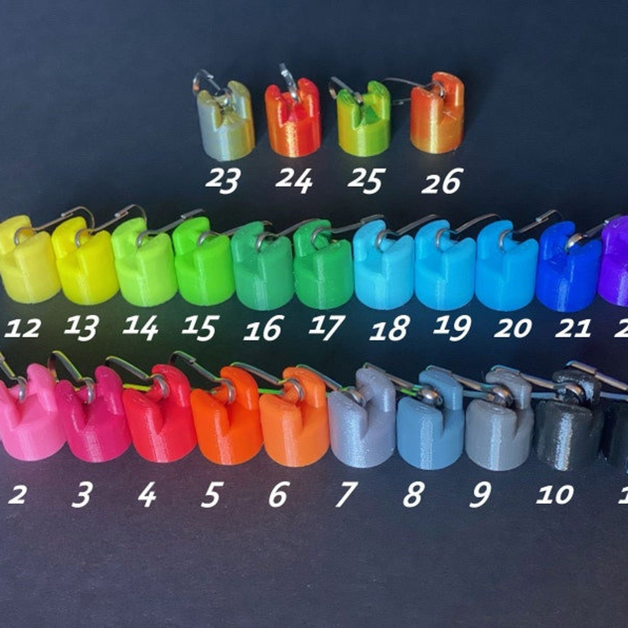 Colored plastic clips with metal hardware, various colors and numbers visible