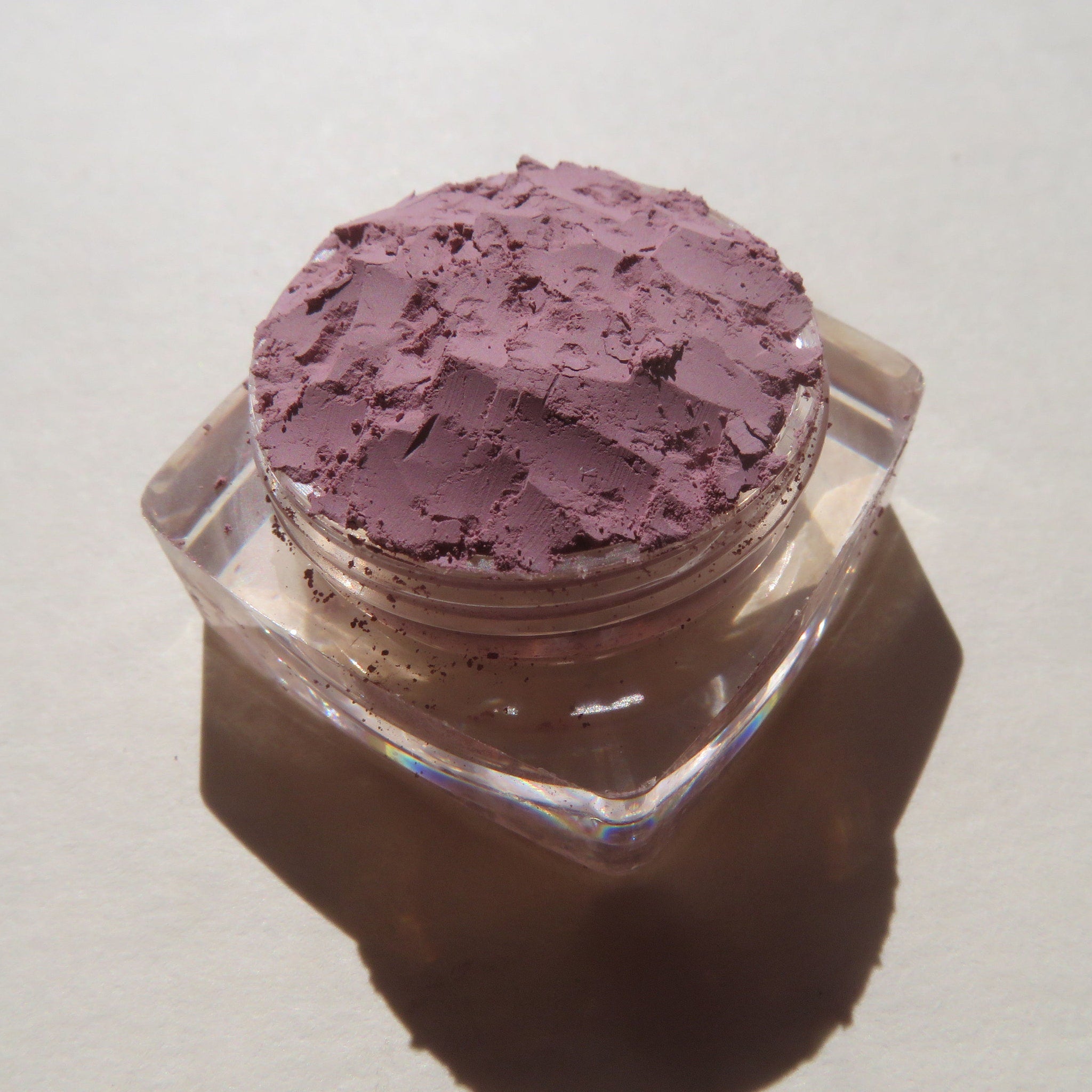 Open compact showing matte light purple Persian Lily eye shadow with smooth mineral powder texture