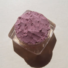 Side view of matte light purple loose mineral eye shadow in Persian Lily shade, showcasing fine powder texture