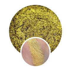 Eye makeup product with gold shimmer and texture, shown swatched on skin