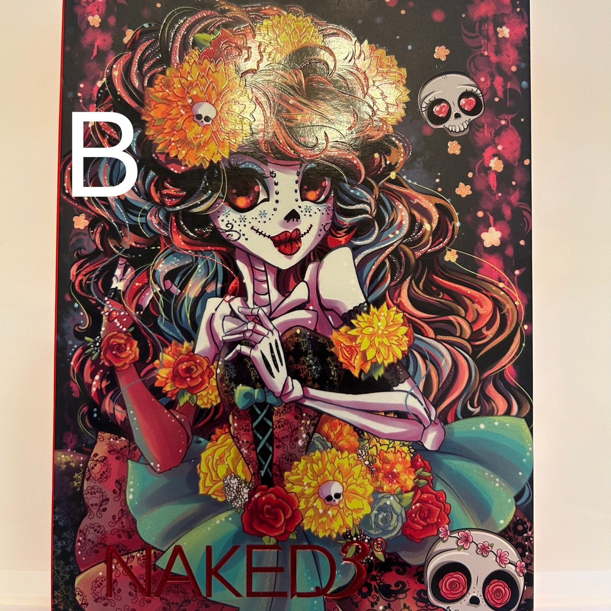 Close-up of vibrant orange and black eye shadow palette with shimmer finish, showcasing Halloween-themed color gradient