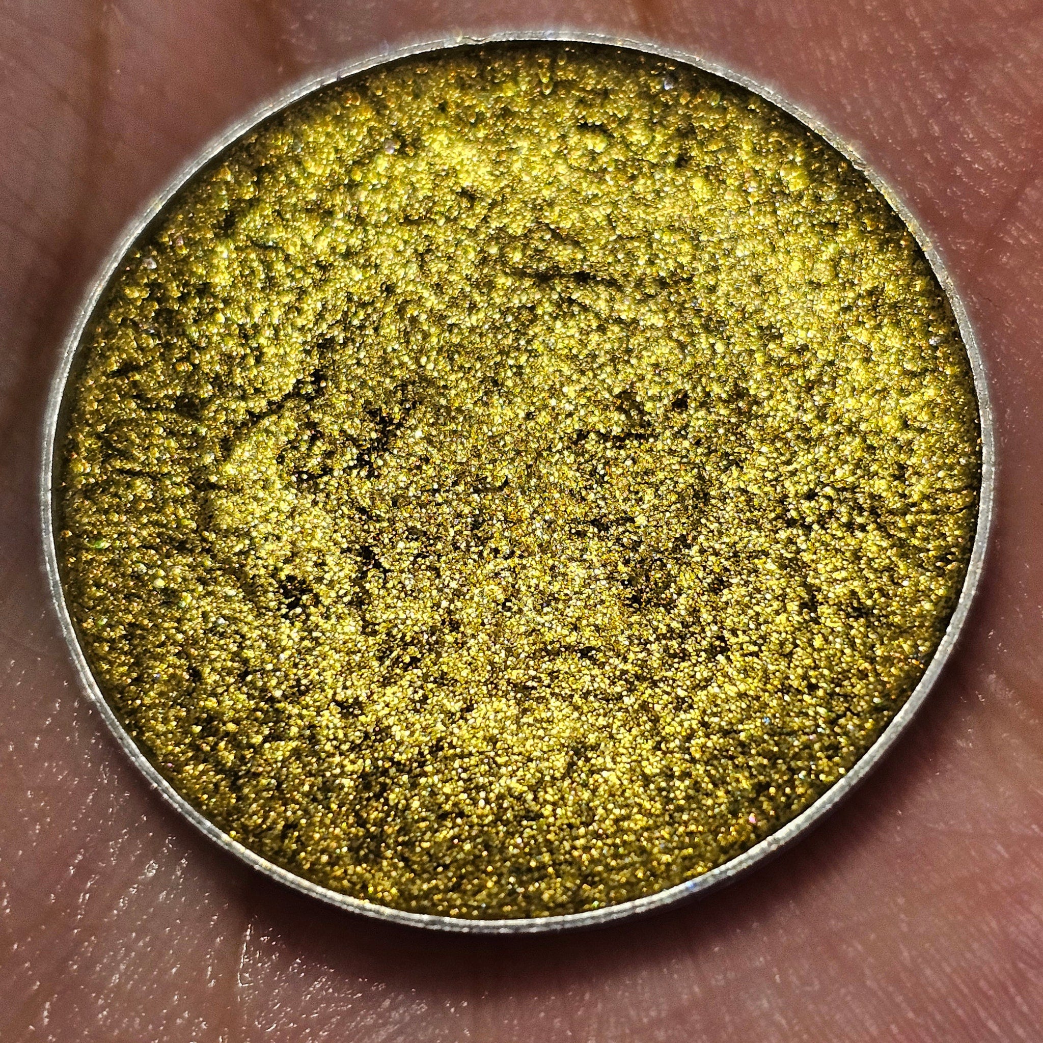 Side view of Angelus Witch Blade multichrome pressed pan showing color shift from purple to green shimmer.