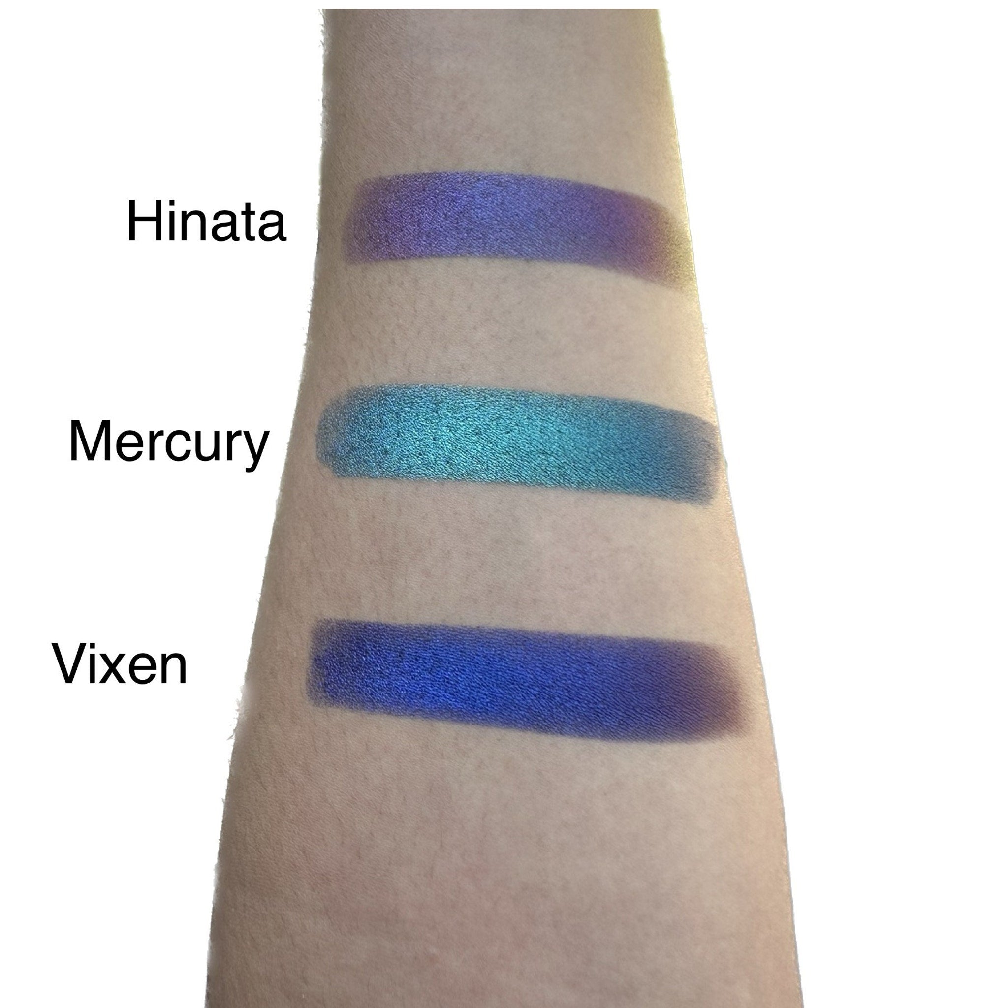 Side view of duo chrome eye shadows in sleek case showcasing iridescent color shift and compact size