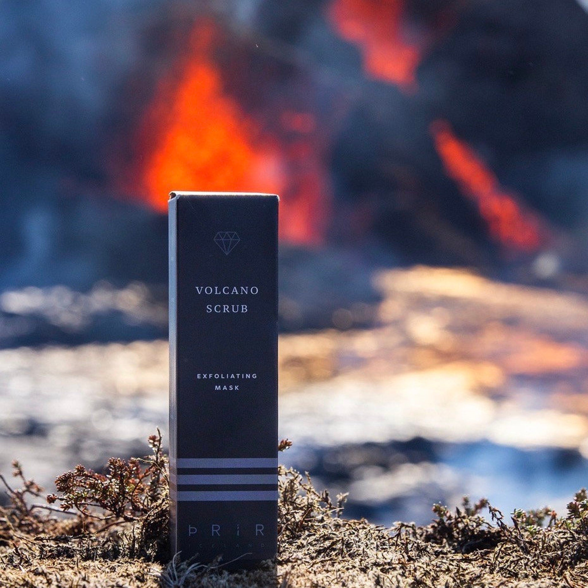 Volcano scrub box, black with white text, PRIR brand name, on a rocky surface with blurred background