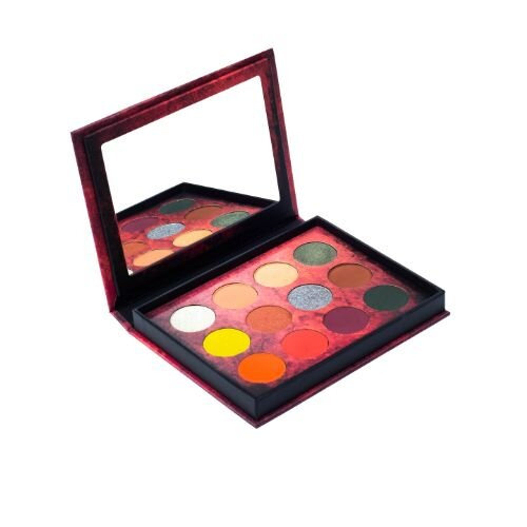Close-up of Dream Demon palette showing shimmering emerald and onyx eyeshadows with smooth, blendable texture