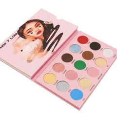 Woman applying shimmering bronze eyeshadow from palette with tapered brush, blending along eyelid crease