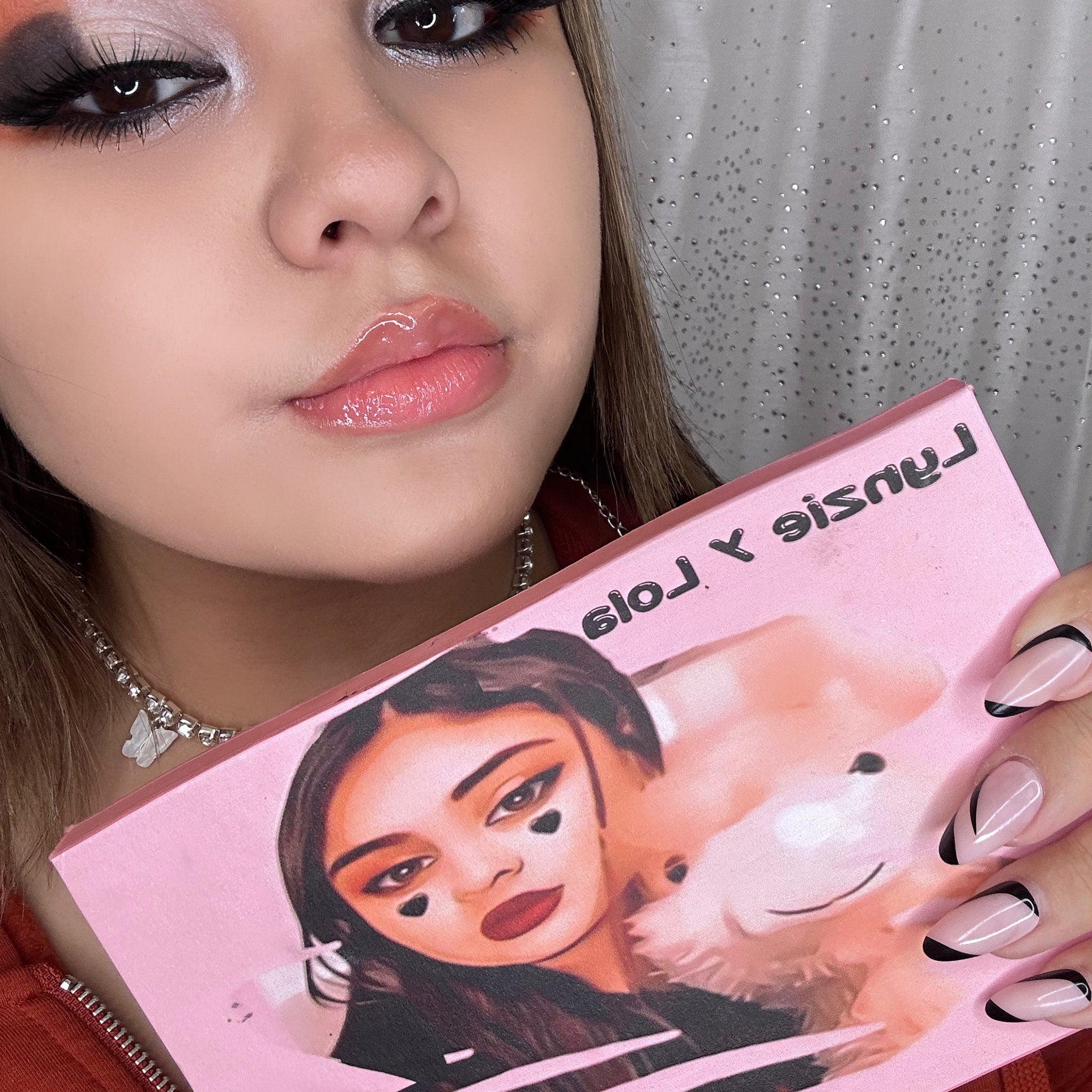 Close-up of Lynzie & Lola eyeshadow palette showing shimmering bronze and plum shades with smooth powder texture