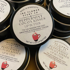 Lip butter tins with black lids, white labels, and Ink Flower Scent Co branding