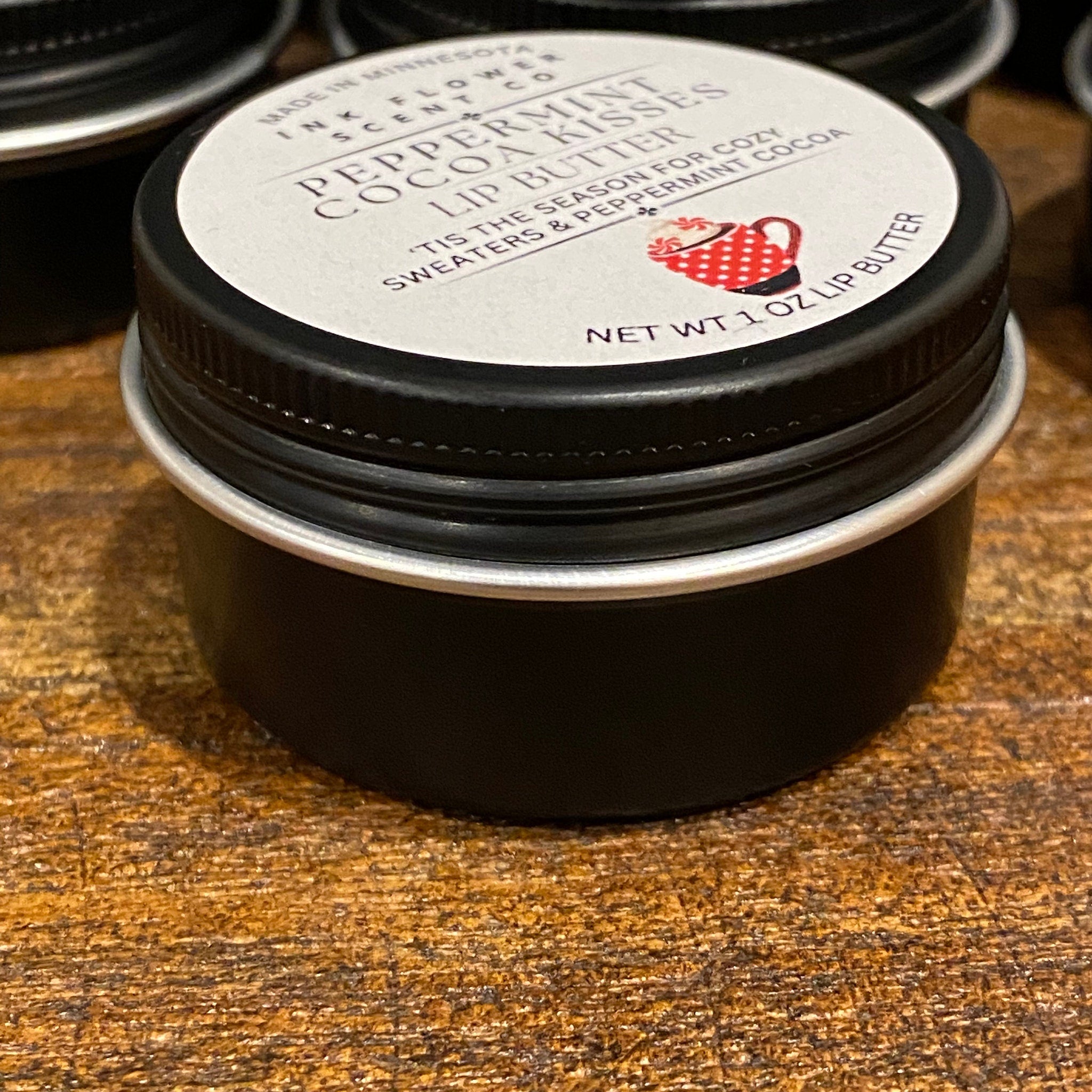 Lip butter jar with black metal lid and white label, Ink Flower Scent Co. brand