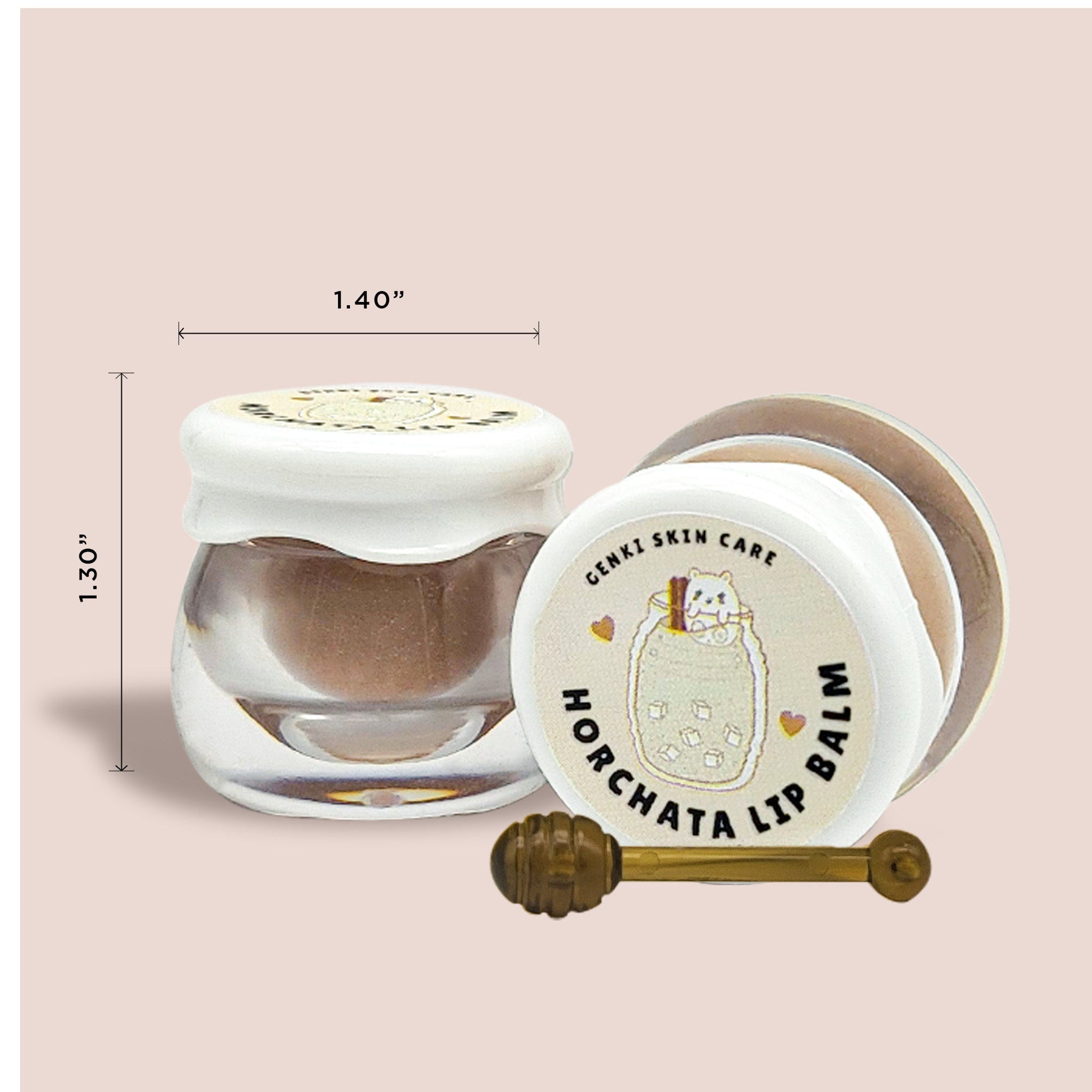 Lip balm in clear glass jar with white lid, brown contents, and gold stirrer
