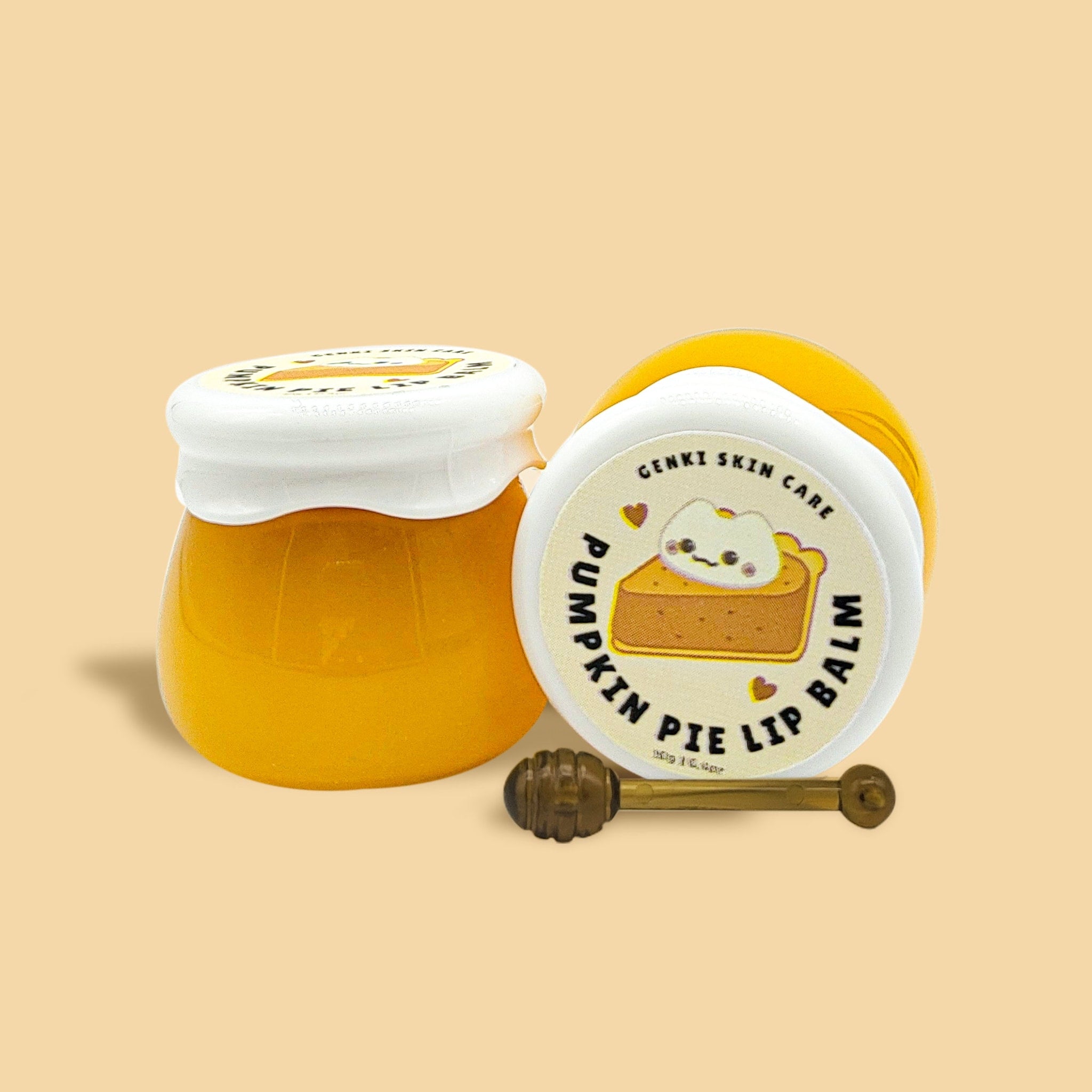 Lip balm jars, yellow and white, with Genki Skin Care label and honey dipper