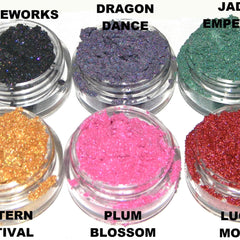 Close-up of fingertips applying shimmery gold eyeshadow to eyelid for festive Lantern Festival look