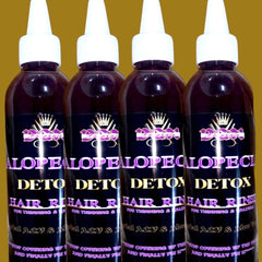 Side view of sleek amber dropper bottles with gold caps showcasing alopecia growth serum set on marble surface