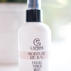 Facial toner mist bottle, white plastic with black cap, Caprine Cosmetics branding visible