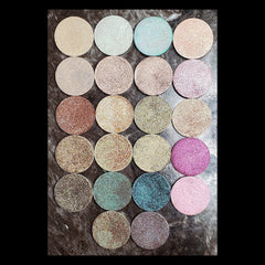 Circular magnetic eyeshadow refills in duochrome shades with metallic finish, arranged in palette.