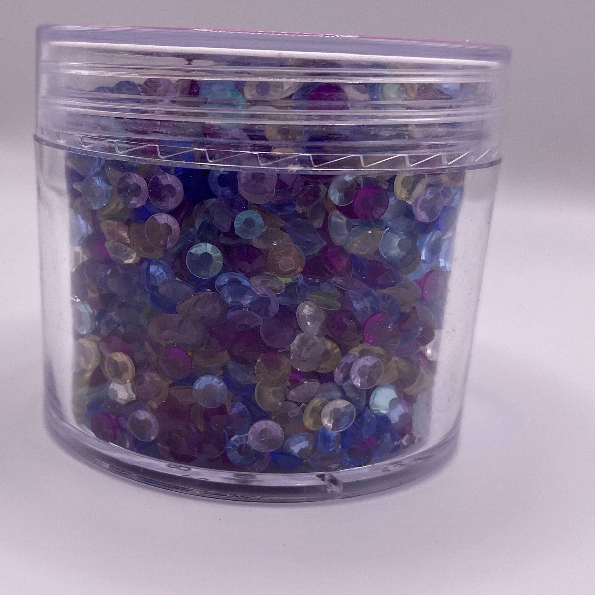 Rhinestones in clear plastic jar with assorted colors and faceted style