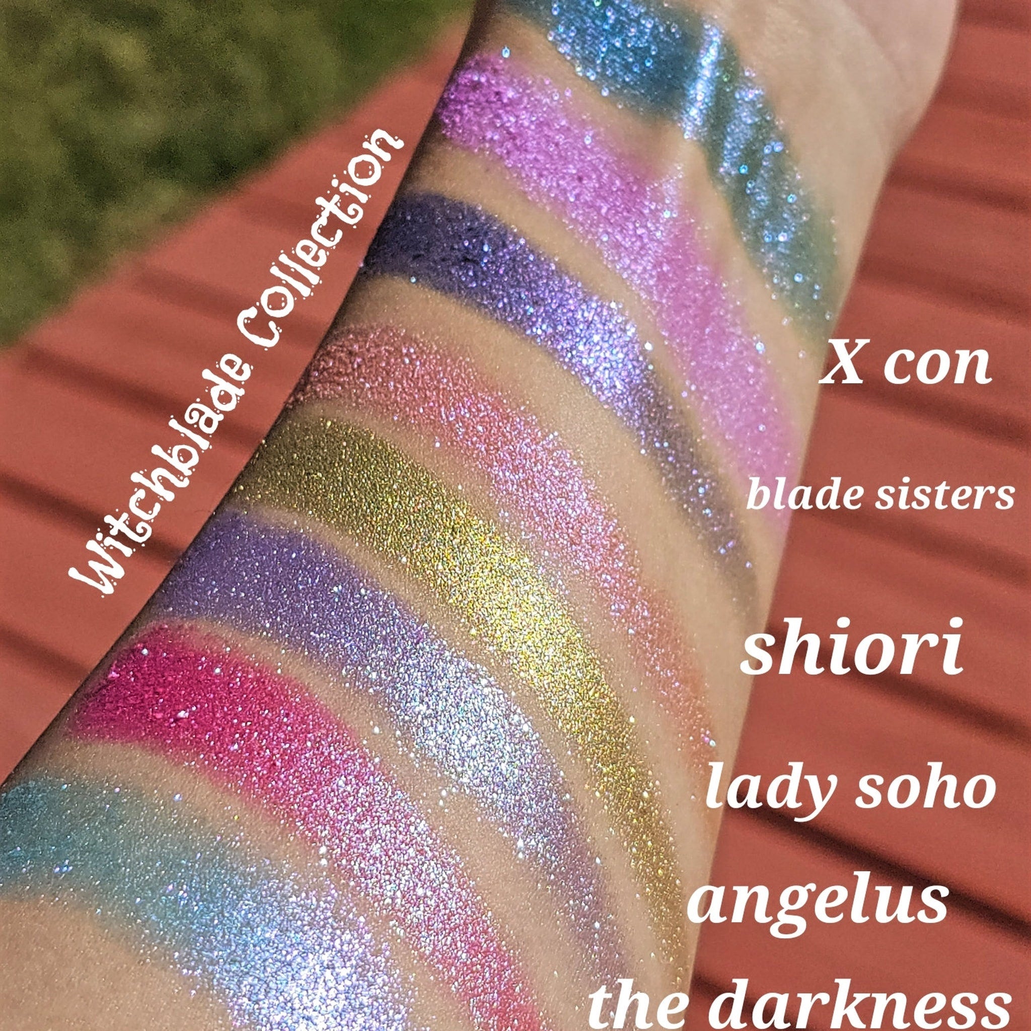 Glitter eyeshadow swatches in various colors, Witchblade Collection text visible, applied on arm