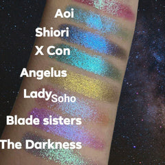 Glitter eyeshadow swatches in various colors, including blue, green, and purple, on arm skin, with text labels