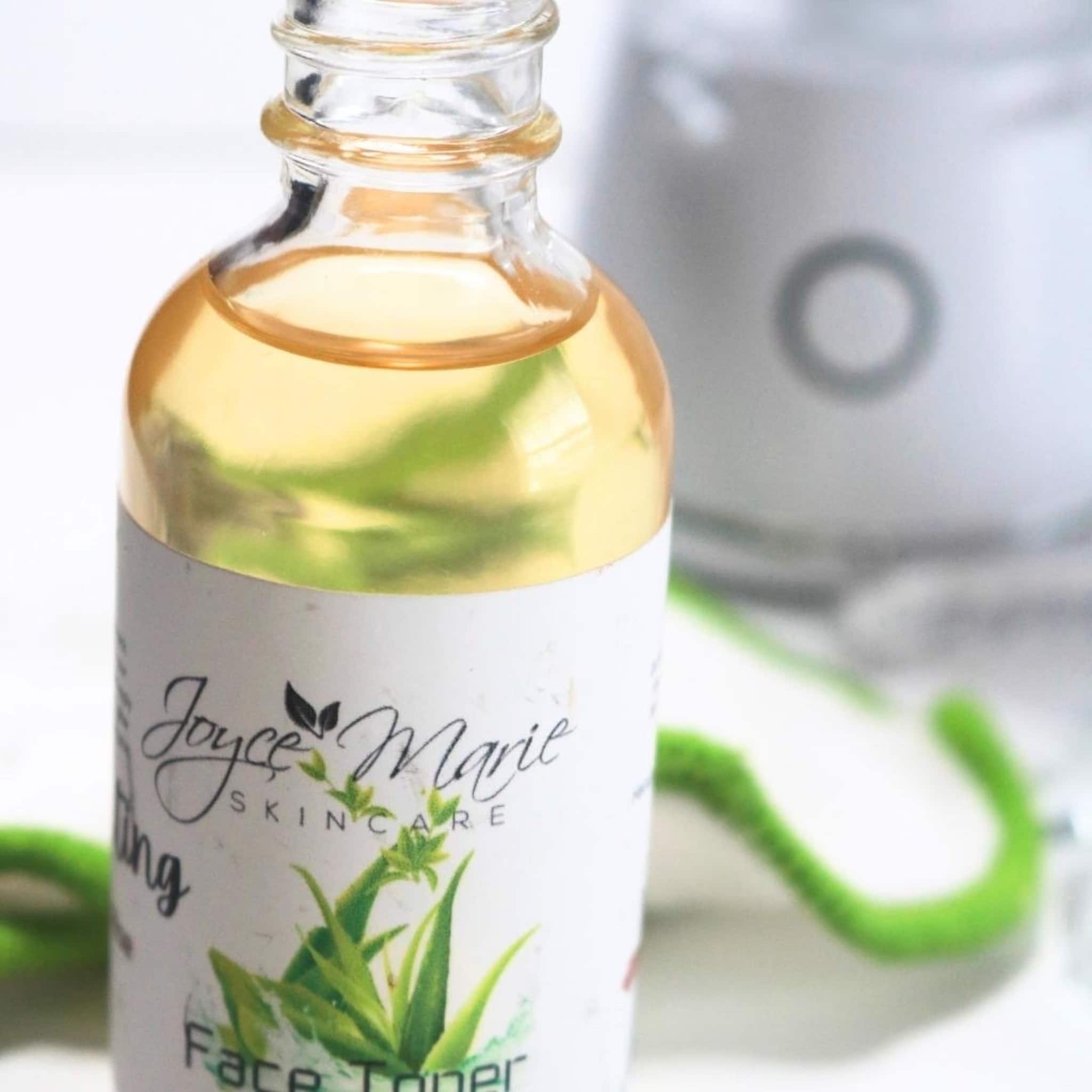Face toner bottle with clear glass, yellow liquid, and Joyce Marie Skincare label