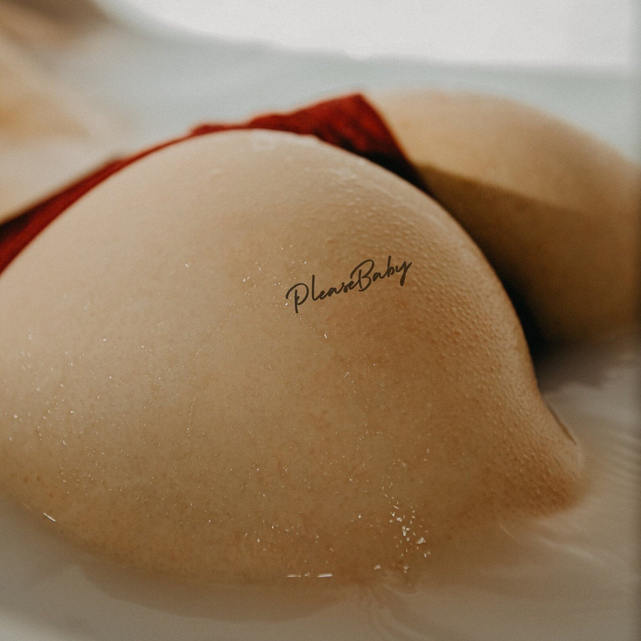 Elegant black-and-gold temporary tattoo sheets displayed on marble surface with skincare aesthetic