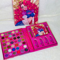 Pink eyeshadow palette with six shimmering shades displayed open on a marble surface