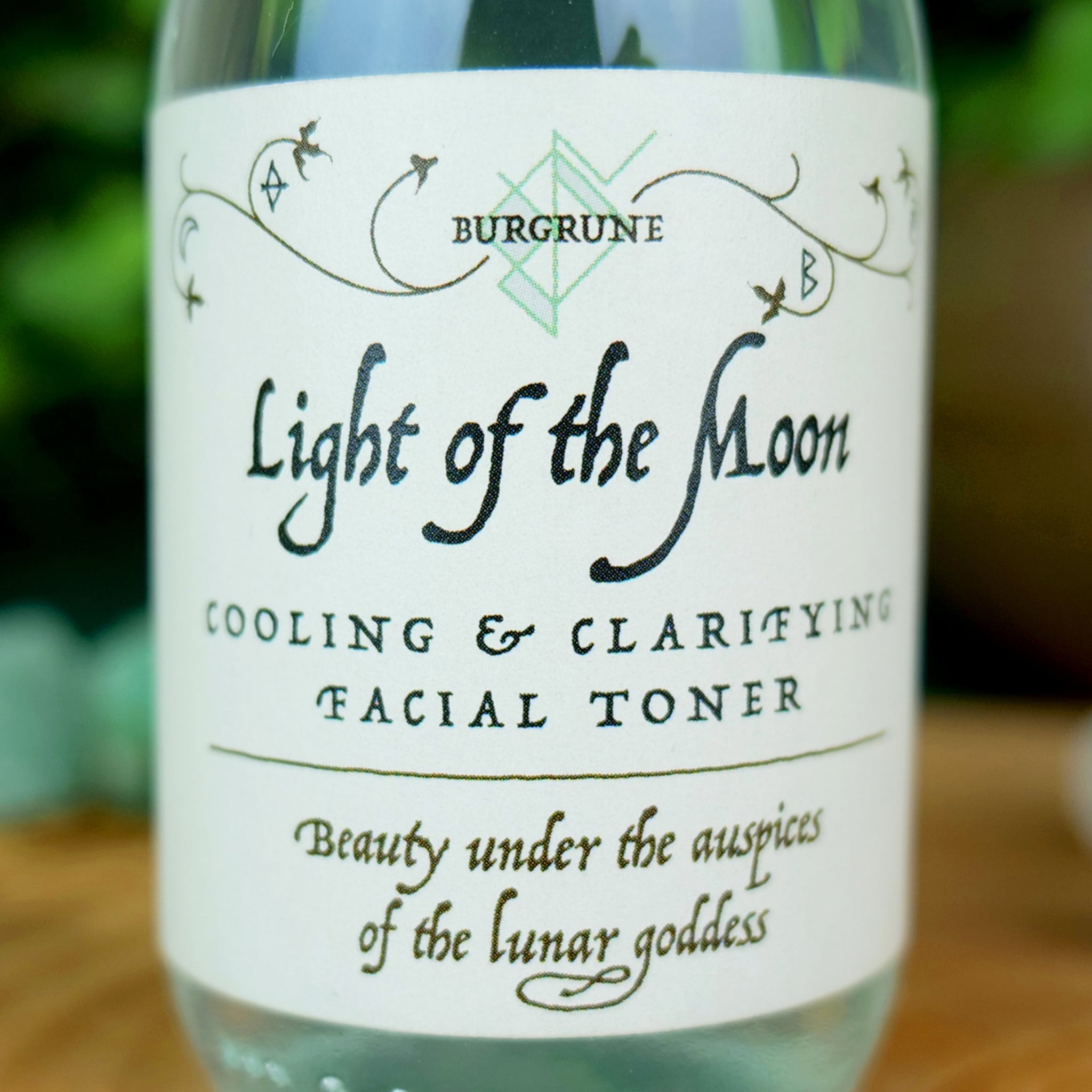 Facial toner bottle with white label, black text, and BURGRUNE brand name visible