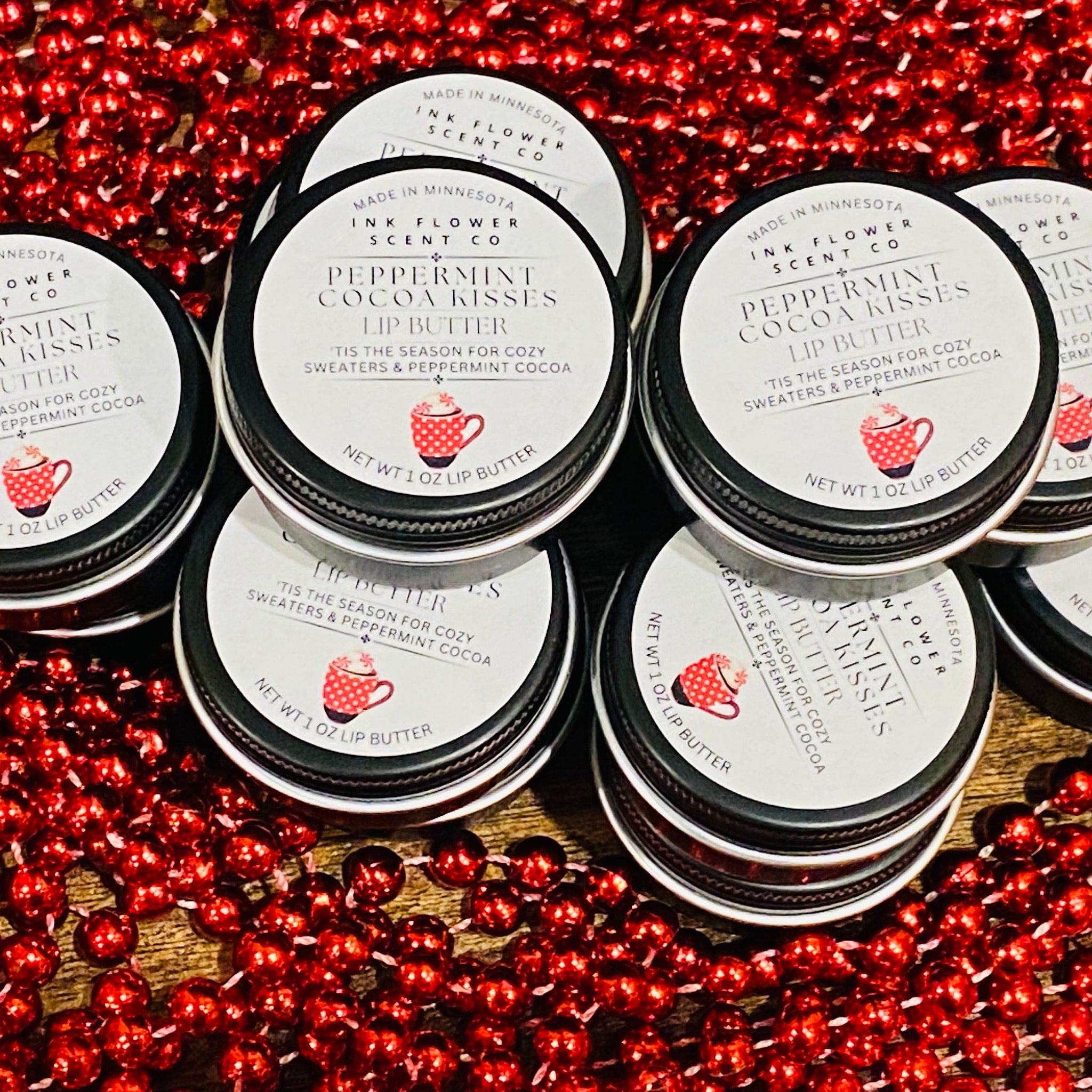 Lip butter tins with black lids, white labels, and red polka dot mug illustration, by Ink Flower Scent Co