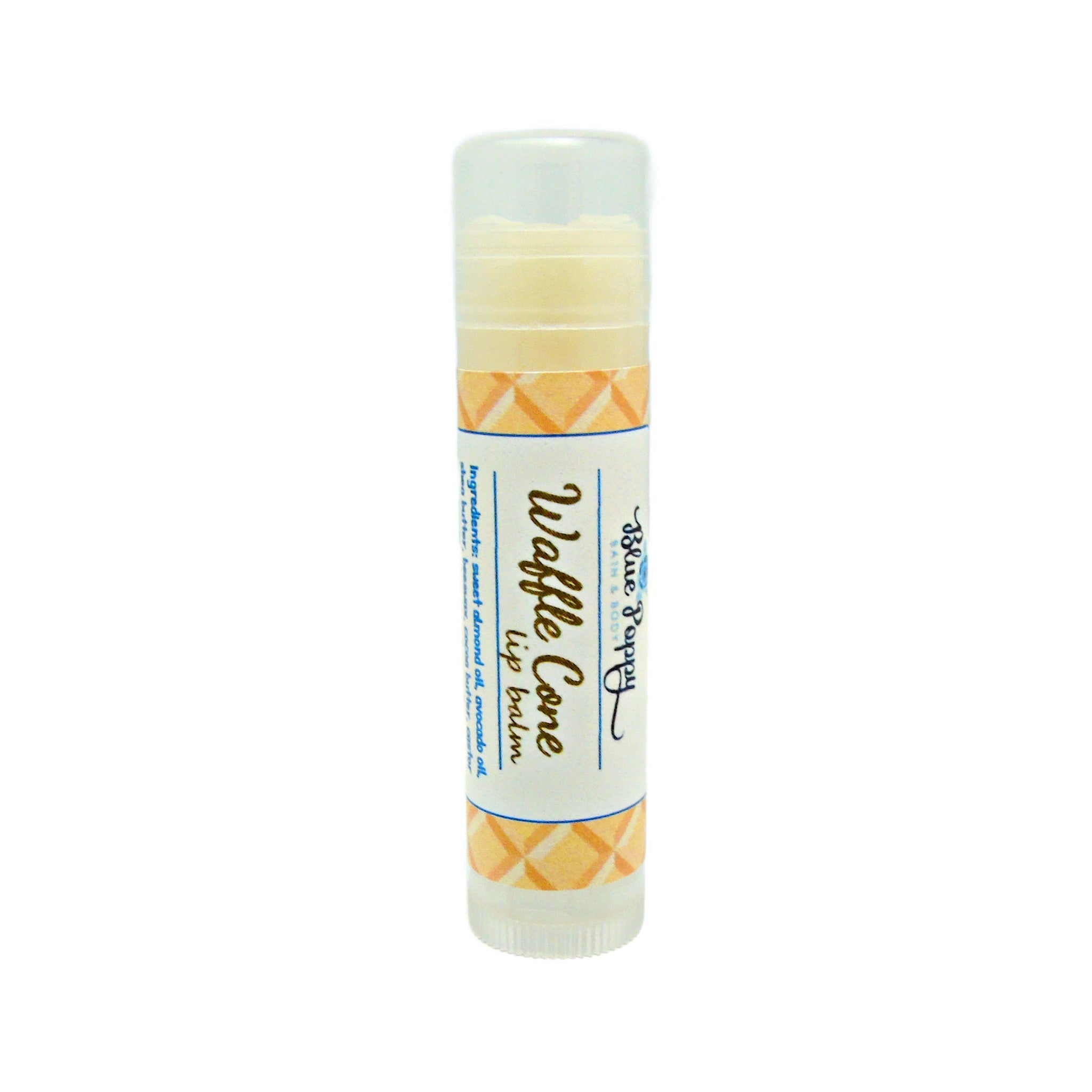 Lip balm tube with clear cap, yellow and orange patterned label, Blue Poppy brand