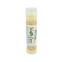 Lip balm tube with clear cap, yellow and orange patterned label, Blue Poppy brand
