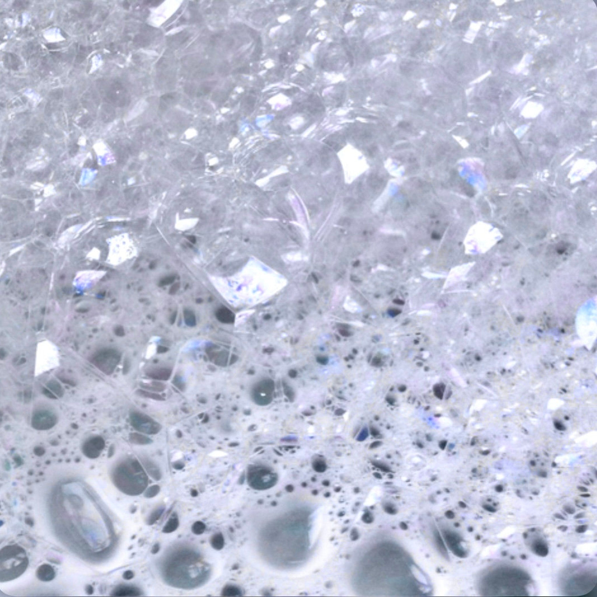 Bubbles, white and clear, with iridescent highlights and varying sizes