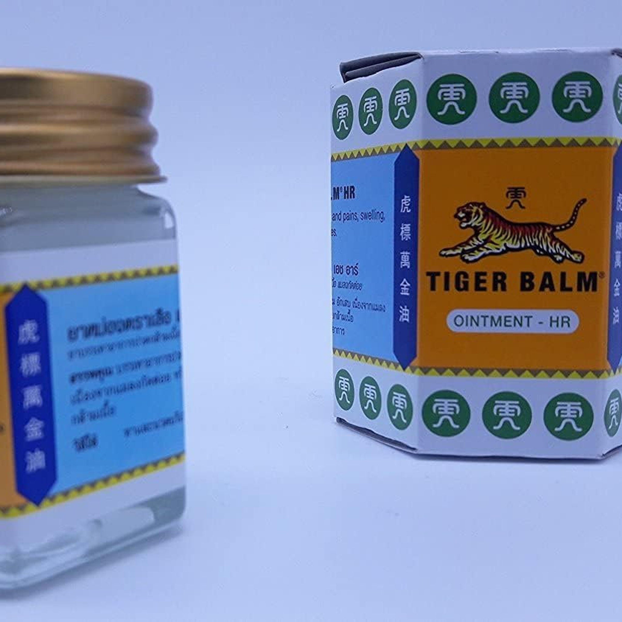 Side view of White Tiger Balm Skin Relief tube showing sleek silver cap and textured cream dispenser
