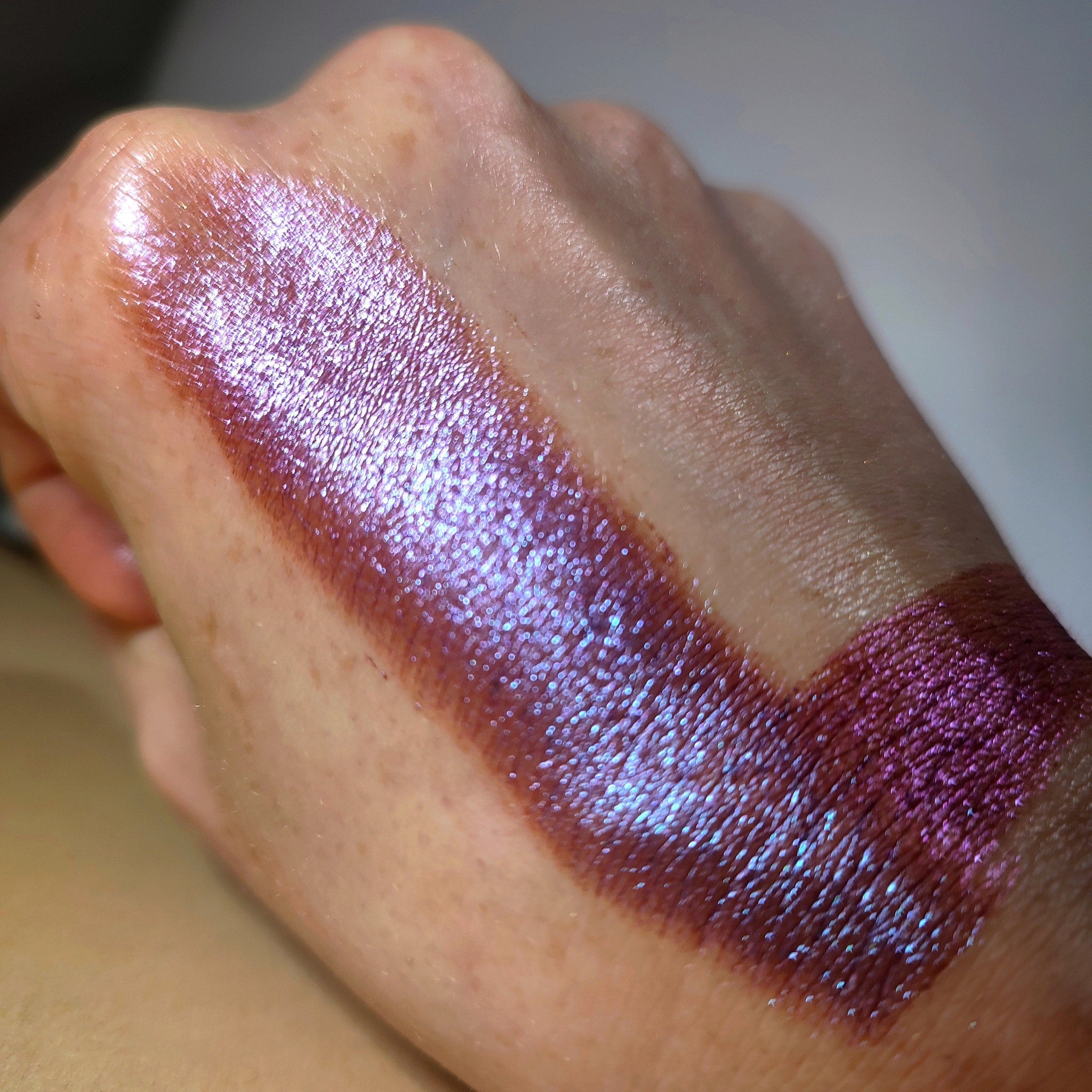 Close-up of Berys Eye Shadow palette showing shimmering bronze and taupe shades with smooth powder texture