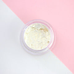 Close-up of Champagne Fizz liquid eyeshadow in sparkly gold with metallic sheen and doe-foot applicator