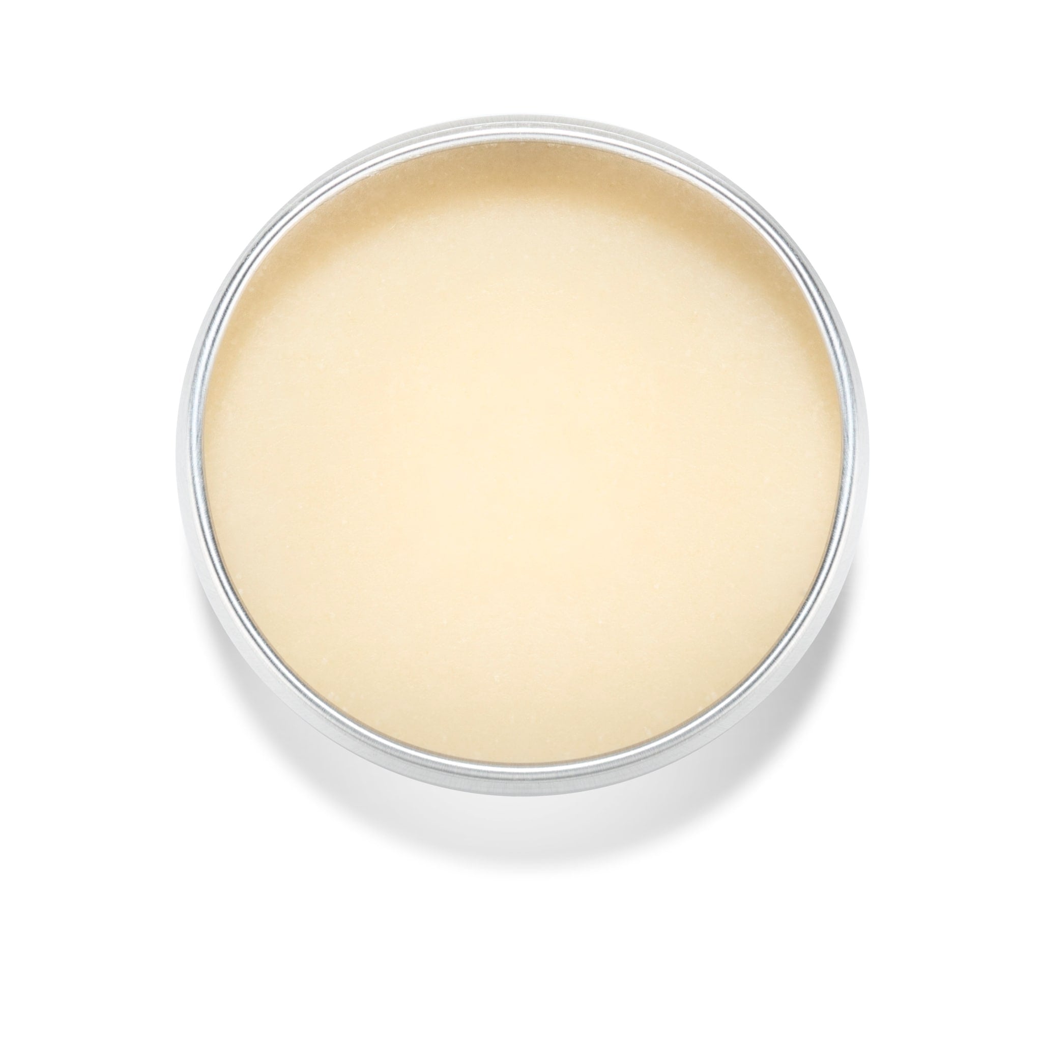 Balm in metal tin, light yellow color, round shape, overhead view
