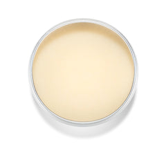 Balm in metal tin, light yellow color, round shape, overhead view